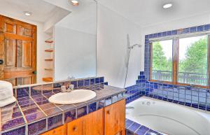 a bathroom with a tub and a sink at 1477 Salt Ash Road in Plymouth +17 photos