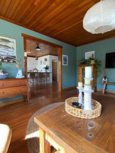 a living room with a table and a dining room at Lylah’s By The Sea in Wynyard