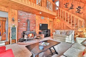 a living room with a fireplace and a brick wall at 278 Ghia Farm Road in Ludlow