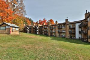 a row of apartment buildings in a park at Okemo Mountain Lodge in Ludlow