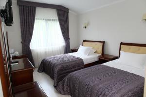 Ένα ή περισσότερα κρεβάτια σε δωμάτιο στο Prima Villa Guest House