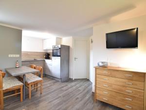 a kitchen with a table and a dining room at Ground-Floor Getaway with Garden in Insel Poel +28 photos