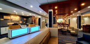 a hotel lobby with a couch and a bar at Holiday Inn Express - Wells-Ogunquit-Kennebunk, an IHG Hotel in Wells
