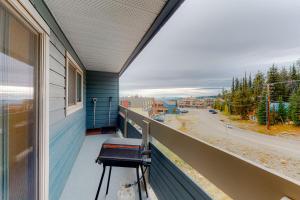 a balcony with a chair and a view of a street at Powder Family - Ptarmigan Inn #302 in Big White