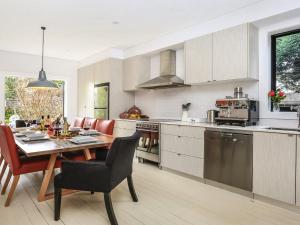 a kitchen with a wooden table and a dining room at Lovett in Mittagong