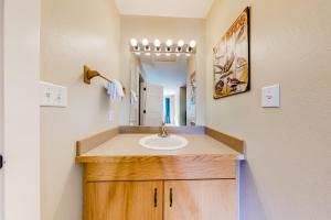 a bathroom with a sink and a mirror at Firelight Chalet 94 in Big Sky
