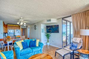 a living room with a blue couch and a table at Ocean Front, Private Balconies in Myrtle Beach