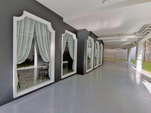 a hallway with a row of paintings on the wall at The Lantern Hatyai Hotel in Hat Yai