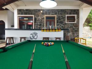 a pool table in front of a house at Sunchaser Beach Hotel in Tangalle