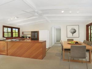 a kitchen and dining room with a table and a counter at Que Sera in Bowral