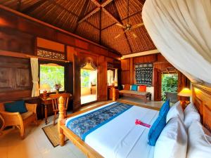 a bedroom with a large bed in a room at Alam Indah Ubud in Ubud +126 photos