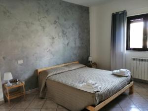 Ένα ή περισσότερα κρεβάτια σε δωμάτιο στο B&B Ginevra