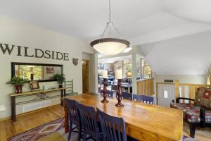 a dining room with a wooden table and chairs at Gateway to the Wildside Townhouse in Estes Park