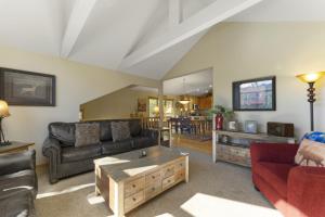 a living room with a couch and a coffee table at Gateway to the Wildside Townhouse in Estes Park