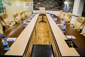 a conference room with a long table and chairs at Saffron D'or Hotels in Lahore