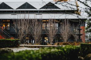 a large building with trees in front of it at Hotel Bellinzona Daylesford in Hepburn Springs