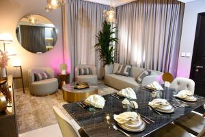 un soggiorno con tavolo da pranzo e un soggiorno con pareti rosa di Smart Living Villa a Dubai