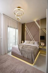 a bedroom with a large bed and a large window at Smart Living Villa in Dubai