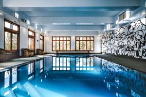 a swimming pool in a house with a mural at Hotel Bellinzona Daylesford in Hepburn Springs