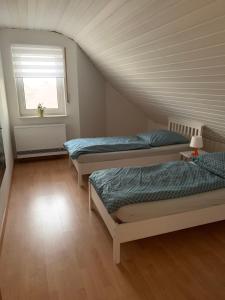 a room with three beds and a window at Casa Blanca 3 in Ottenheim