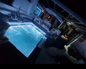 an overhead view of a swimming pool at night at ALOELUX VILLA ! - Private Villa with Jacuzzi, cinema ,massage ,wonderful view, art desing villa in Conil