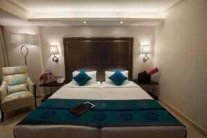 a hotel room with two beds and a table at Savera Hotel in Chennai