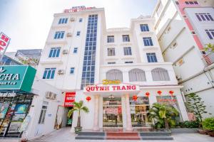 a white building with a sign in front of it at Quỳnh Trang in Thường Son