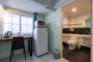 a kitchen with a refrigerator and a table and a toilet at Little Bear's Home in Chiang Mai +85 photos