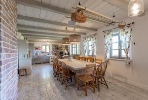a kitchen and dining room with a table and chairs at Chalupa Paseky in Vápenice