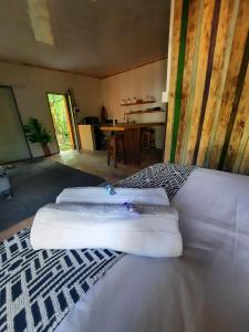 a room with three white towels on top of a bed at Vulture's View 3 in Hartbeespoort