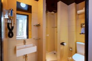 
a bathroom with a toilet a sink and a shower at Hôtel Palais De Chaillot in Paris
