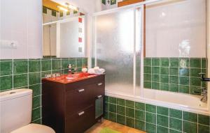 a green tiled bathroom with a toilet and a sink at Beautiful Home In Cómpeta in Sayalonga +25 photos