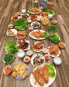 a group of plates of food on a wooden table at An Viên House Sóc Sơn Venuestay in Hanoi