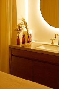 a bathroom counter with a sink and a mirror at Le Nessay in Saint-Briac-sur-Mer