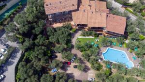 a large building with a lot of trees at Hotel Coste in Limone sul Garda