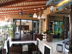 a restaurant with a patio with a table and chairs at Cocoville Phuket - SHA Plus in Chalong