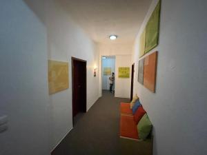 a hallway with paintings on the walls and a person in the distance at CCH Hamburg Zentrum in Hamburg
