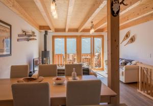 a dining room and living room with a table and chairs at Racers Retreat #5 in Wengen