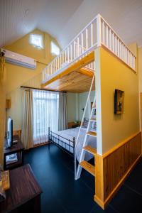 a room with a bunk bed and a staircase at Baroque Boutique Resort in Ranong