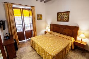 Postel nebo postele na pokoji v ubytování Hostal Loreto