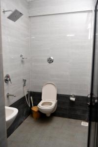 a bathroom with a toilet and a sink at Maria Guest House in Palolem