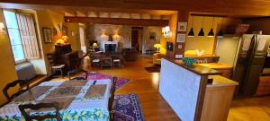 a kitchen and living room with a table in a room at Le Moulin de Mansle in Mansle