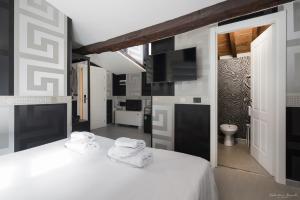 a bedroom with a white bed with towels on it at Hotel Deco in Florence