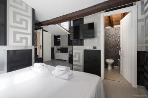 a bedroom with a white bed with towels on it at Hotel Deco in Florence