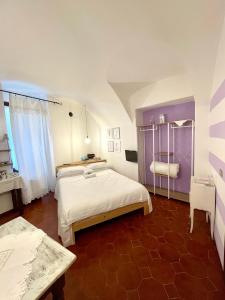 a bedroom with a large bed in a room at STECADÒ - Camera Lavanda in Dolceacqua