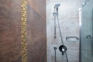 a bathroom with a shower with a glass door at Hotel Baby in Rimini