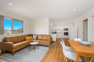 a living room with a couch and a table at Bellhaven 2, 17 Willow Street in Crescent Head