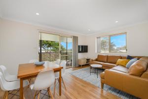 a living room with a couch and a table at Bellhaven 2, 17 Willow Street in Crescent Head