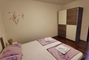 a bedroom with a bed with two towels on it at Apartments Beciri in Sveti Vid-Miholjice +35 photos