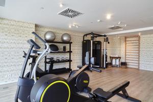 a gym with cardio equipment in a room at Can Salia in San Antonio Bay